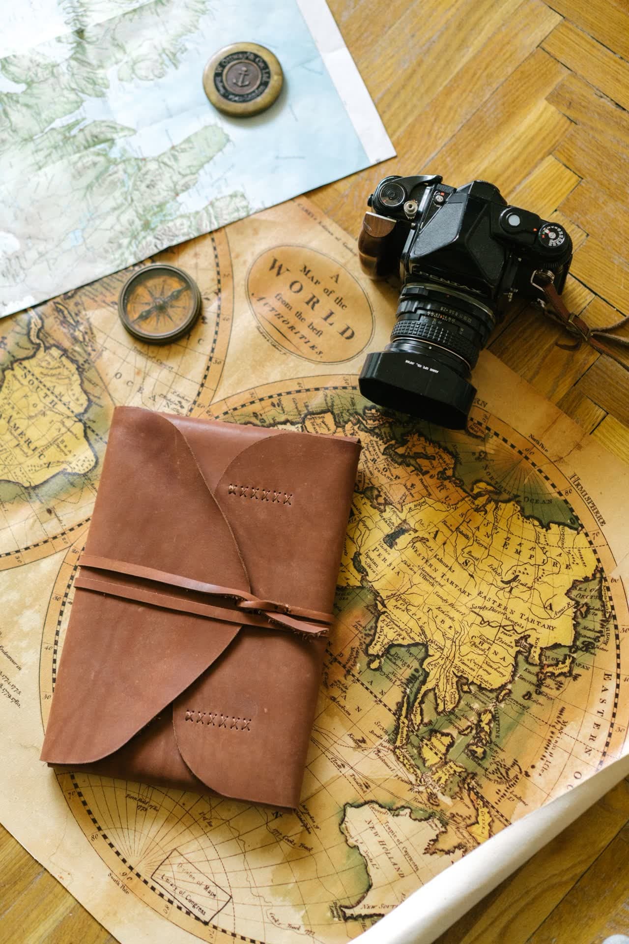 A globe and open notebook on a desk, evoking a journey across languages and cultures